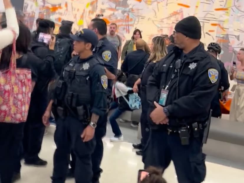 Bystanders at San Francisco International Airport confronting ICE agents during immigration enforcement incident on March 22 2026