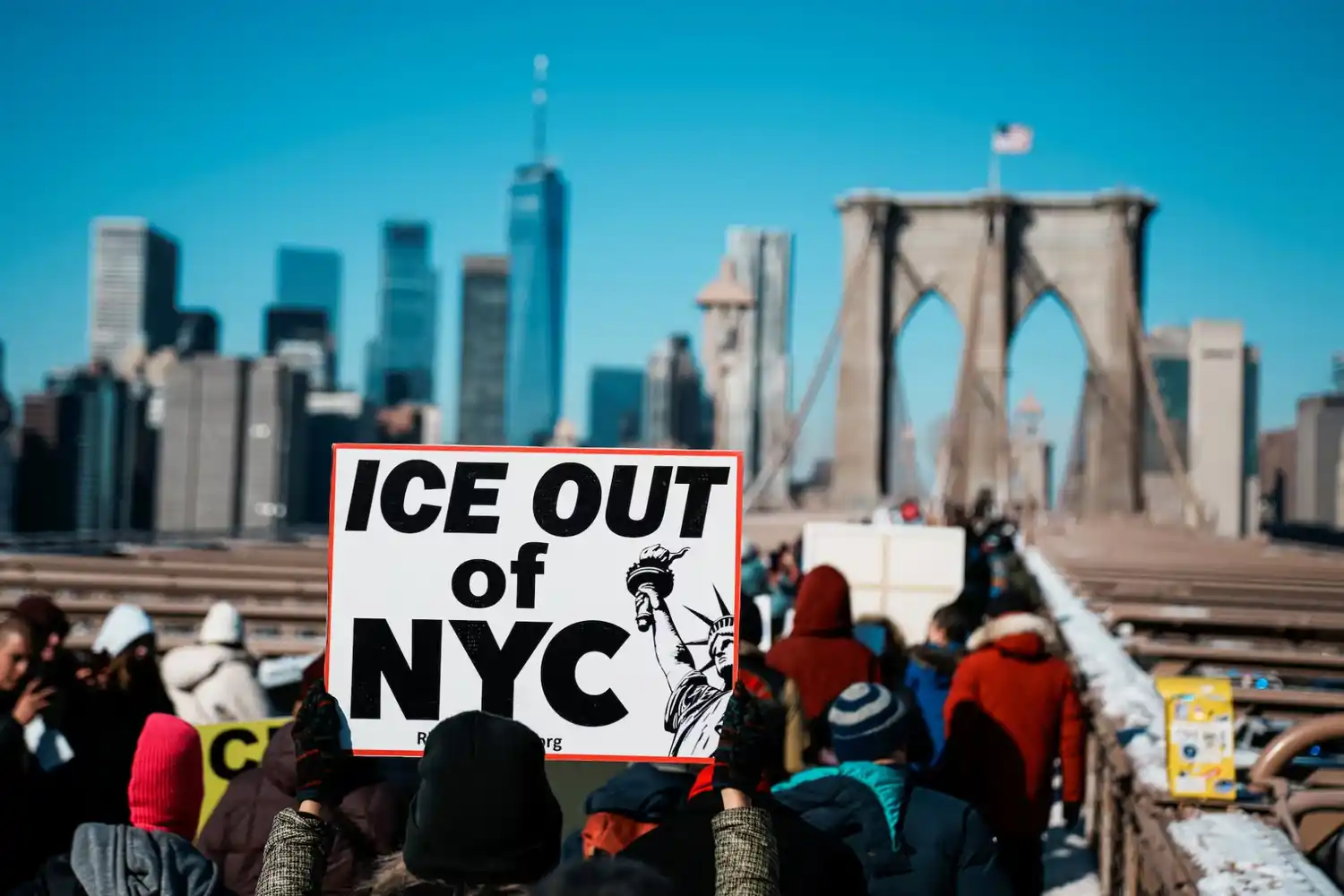 Protesters with cameras and whistles watching federal immigration agents